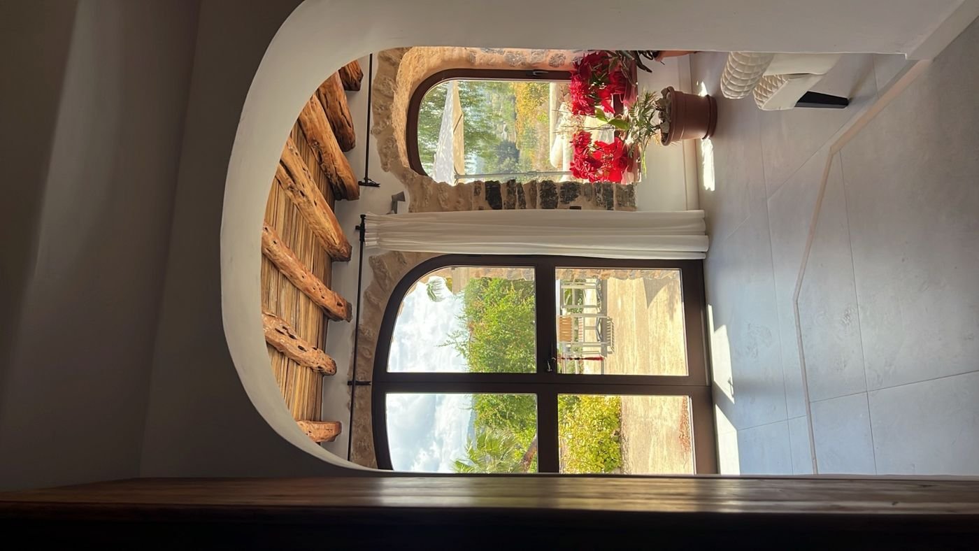 A villa, arches and beams, set for a private dinner