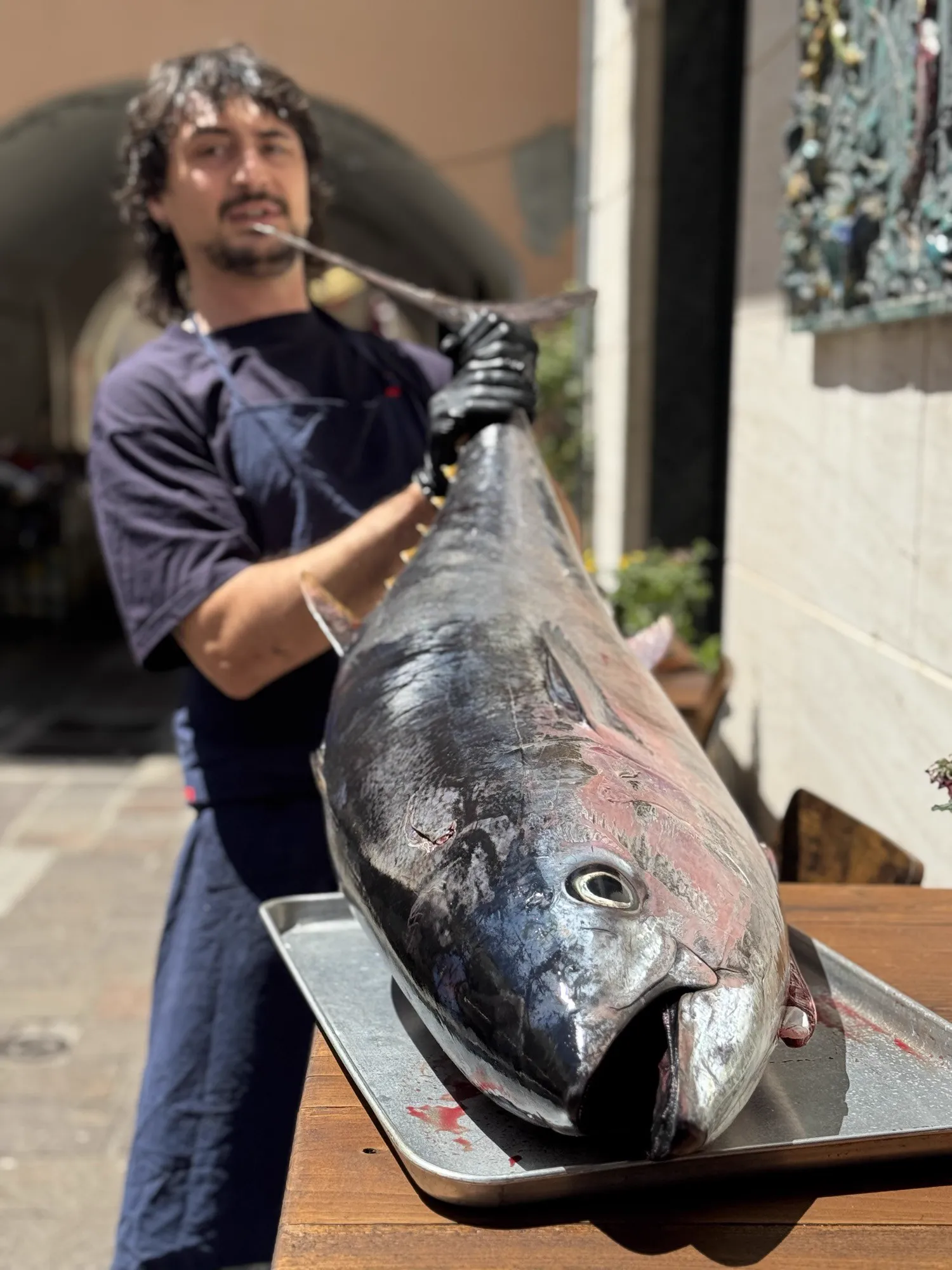 Manuel carrying a whole bluefin tuna